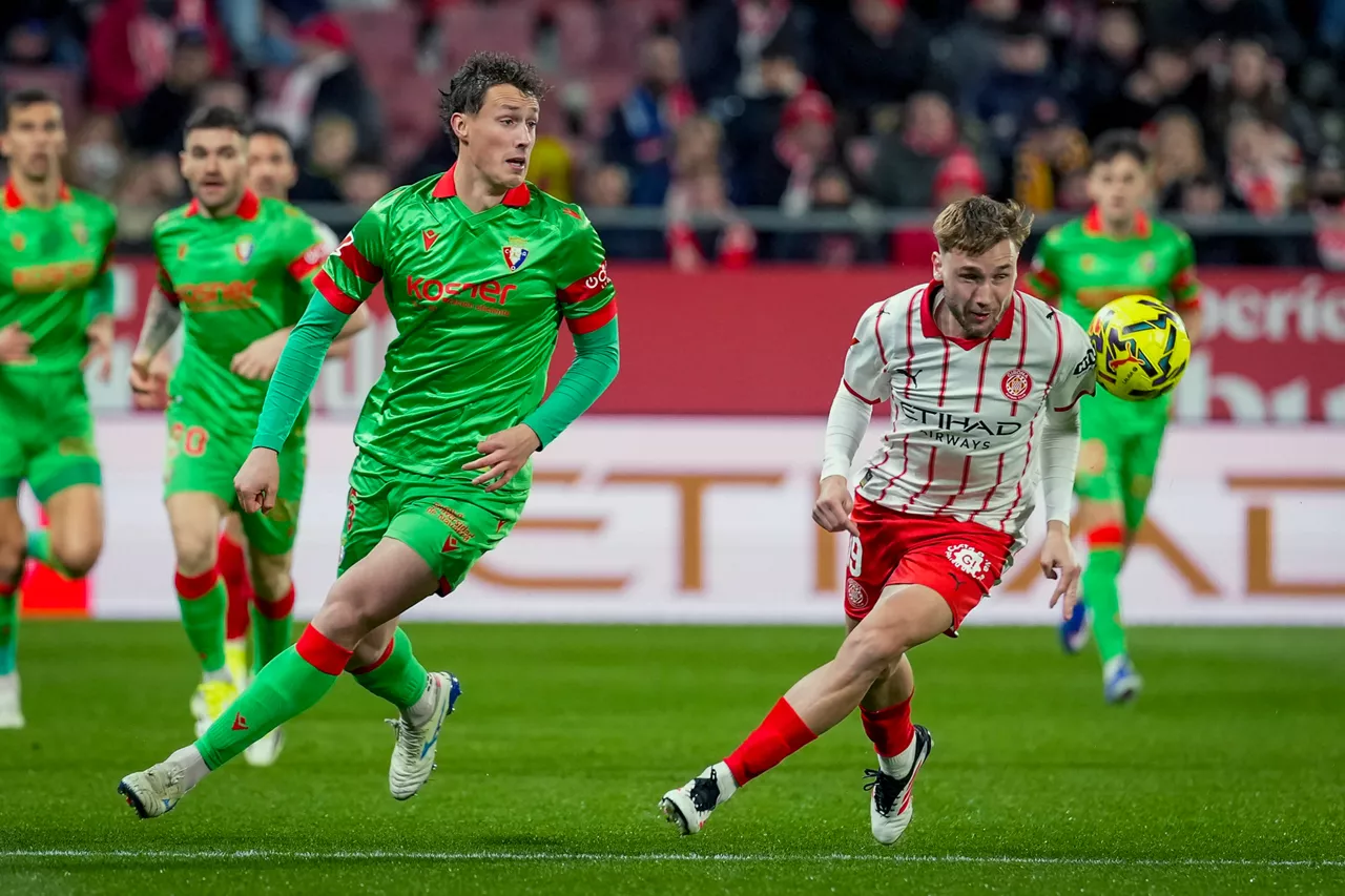 GIRONA, 10/01/2026.- El delantero ucraniano del Girona, Vladyslav Vanat (d), persigue el balón ante el defensa de Osasuna, Jorge Herrando, durante el encuentro correspondiente a la jornada 19 de Laliga EA Sports que disputan hoy sábado Girona y Osasuna en el estadio municipal de Montilivi, en la capital gerundense. EFE/David Borrat.
