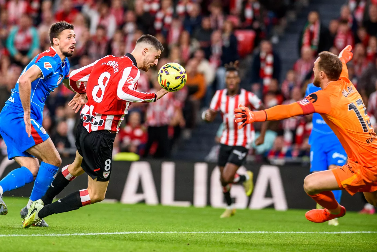 BILBAO, 06/12/2025.- El centrocampista del Athletic Oihan Sancet (c) remata de cabeza a portería ante el portero Jan Oblak (d), del Atlético de Madrid, durante el partido de Liga en Primera División que Athletic Club y Atlético de Madrid disputan este sábado en el estadio de San Mamés, en Bilbao. EFE/Javier Zorrilla
