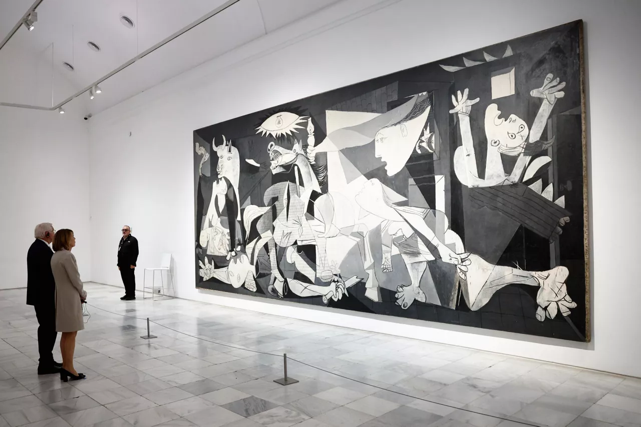 MADRID, 26/11/2025.- El presidente de la República de Alemania, Frank-Walter Steinmeier y su esposa, la primera dama, Elke Büdenbender contemplan el "Gernika", de Pablo Picasso, durante su recorrido por el Museo Reina Sofía, dentro de su visita de Estado, este miércoles en Madrid. EFE/ Rodrigo Jiménez

