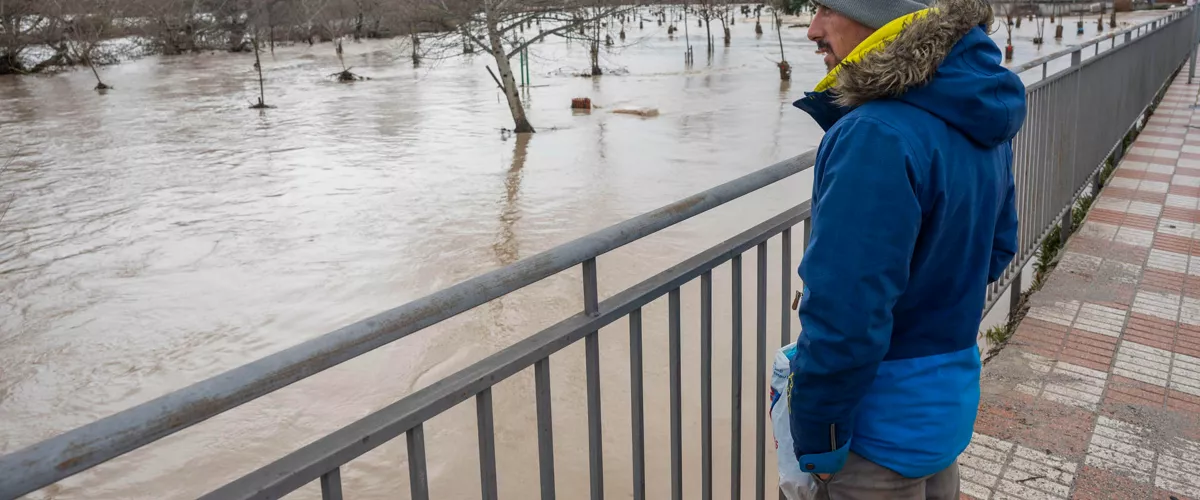 HUETOR TAJAR (GRANADA), 06/02/2026.- Un vecino observa la crecida del río, este viernes en Huétor Tájar (Granada), uno de los municipios andaluces especialmente afectados por la borrasca Leonardo. El presidente de la Junta de Andalucía, Juanma Moreno, ha afirmado este viernes que es posible que sea necesario ampliar el perímetro de evacuación tras el desalojo de la población de Grazalema (Cádiz) debido a los efectos del temporal, aunque la situación la determinarán los geólogos. EFE/ Miguel Ángel Molina
