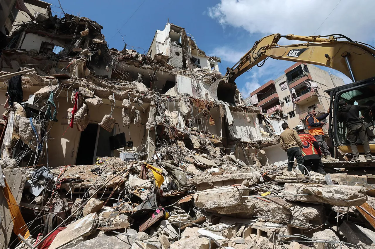 BEIRUT (Lebanon), 10/04/2026.- A bulldozer clears the rubble of a partially destroyed building targeted by an Israeli air strike, during a press tour organized by the Hezbollah media office, in the Hay el-Sellom neighborhood, the southern suburbs of Beirut, Lebanon, 10 April 2026. According to the Lebanese Ministry of Public Health, Israeli attacks across Lebanon have killed at least 1,888 people and injured more than 6,092 others since the start of renewed hostilities between Israel and Hezbollah on 02 March 2026. (Líbano, Hizbulá/Hezbolá) EFE/EPA/WAEL HAMZEH
