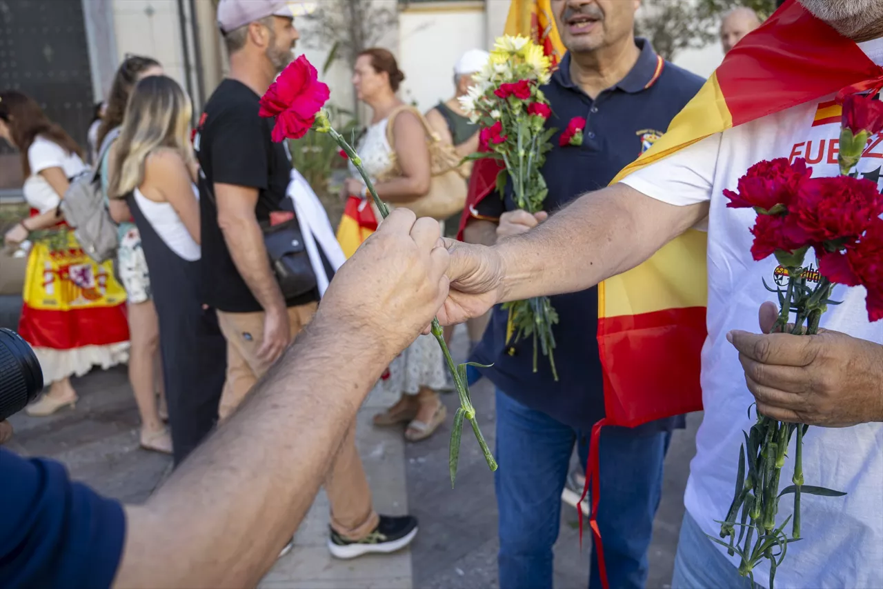 Numerosas personas portan claveles y banderas de España durante una manifestación ante la Delegación del Gobierno, a 28 de agosto de 2026, en Ceuta (España). Un centenar de ceutíes se ha concentrado esta tarde ante la Delegación del Gobierno portando claveles y banderas de Ceuta y España en una protesta con la que han querido reivindicar el carácter pacífico de las movilizaciones ciudadanas surgidas durante los últimos días a raíz de la crisis migratoria que vive la ciudad.



Marcos Moreno / Europa Press

28 AGOSTO 2026 CRISIS MIGRATORIA

28/8/2026