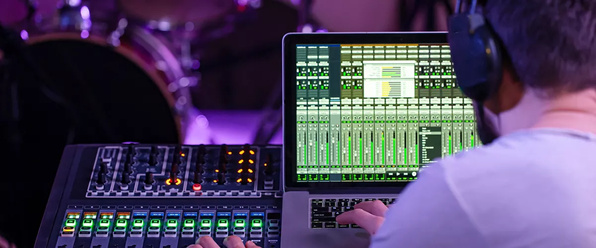 Digital mixer in a recording Studio , with a computer for recording music. On the background of the sound engineer at work. The concept of creativity and show business.