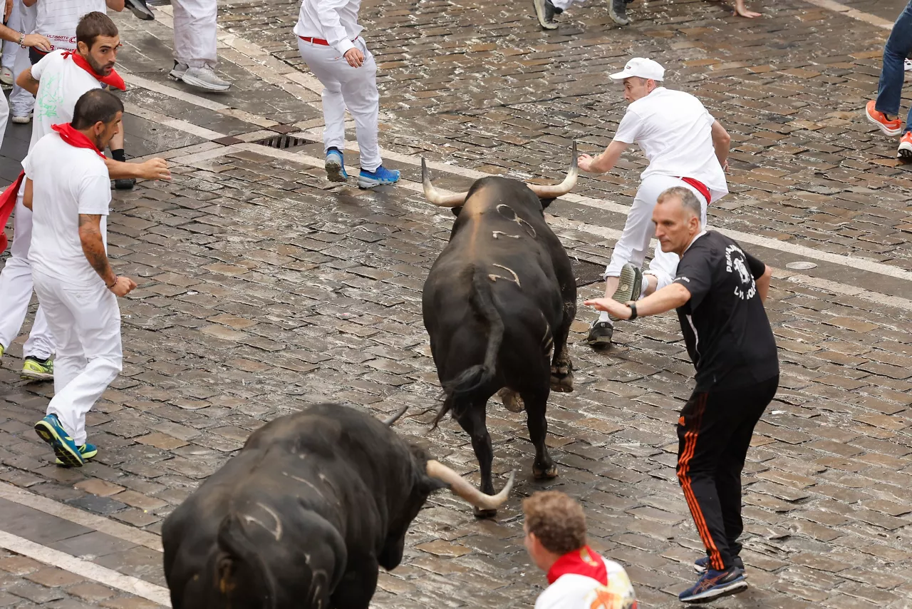 Runners follow the bulls of the Fuente Ymbro cattle ranch in the first lock-up of the 2025 Sanfermines, this Monday in Pamplona. EFE/Villar Lopez